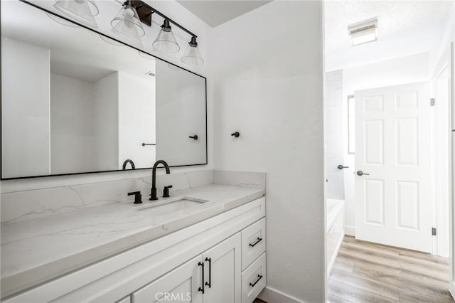 bathroom featuring hardwood / wood-style flooring and vanity