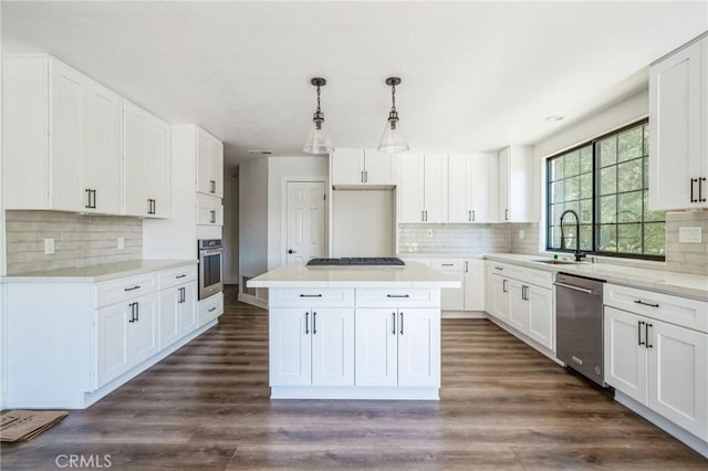 kitchen with white cabinetry, pendant lighting, stainless steel appliances, and a center island