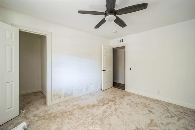 unfurnished room featuring light colored carpet and ceiling fan