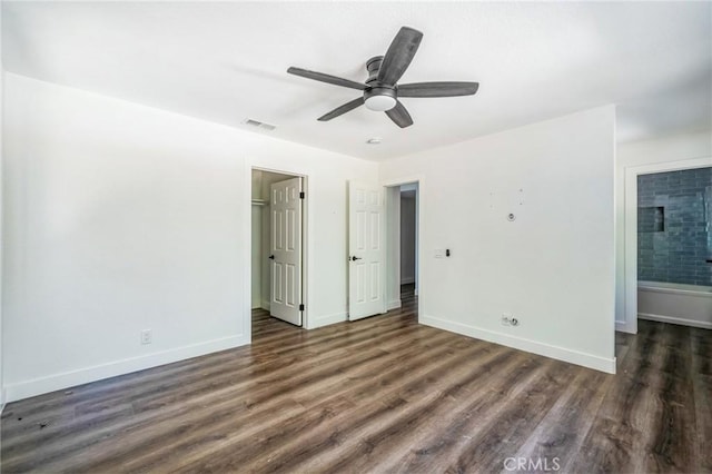 unfurnished bedroom with ceiling fan, connected bathroom, and dark hardwood / wood-style floors