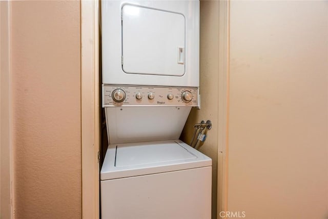 laundry room featuring stacked washer / dryer