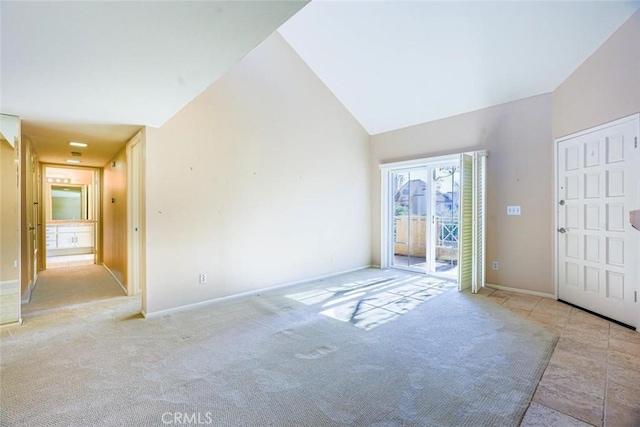 entrance foyer featuring light colored carpet and lofted ceiling