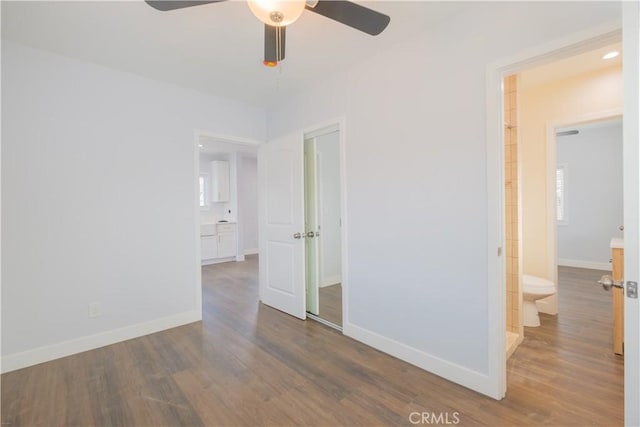 empty room featuring ceiling fan and dark hardwood / wood-style flooring