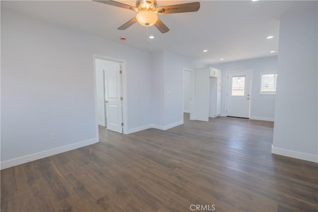 spare room with ceiling fan and dark wood-type flooring