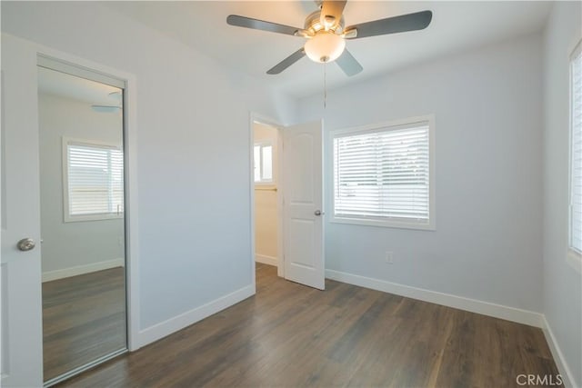 unfurnished bedroom with ceiling fan, dark hardwood / wood-style floors, and a closet