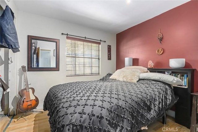 bedroom with hardwood / wood-style flooring