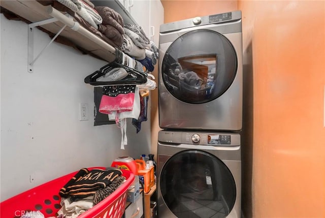 clothes washing area with stacked washer and dryer