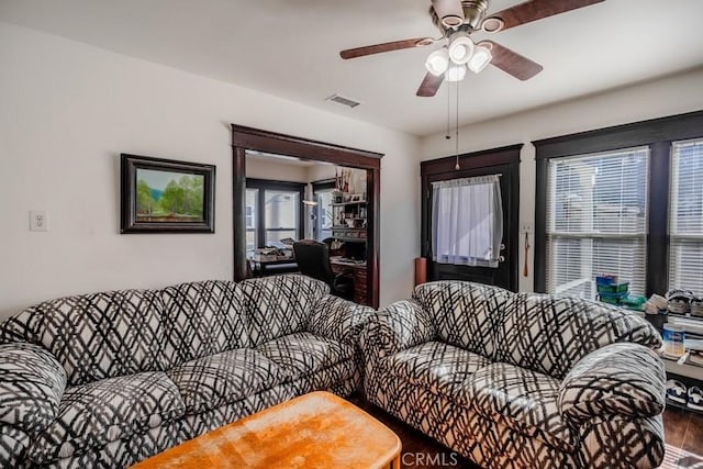 living room with ceiling fan and hardwood / wood-style flooring