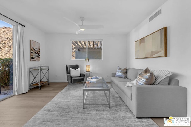 living room with ceiling fan and light hardwood / wood-style floors