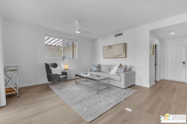 living room featuring ceiling fan and light hardwood / wood-style floors