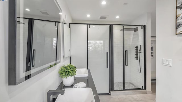 bathroom featuring a shower with shower door and tile patterned floors