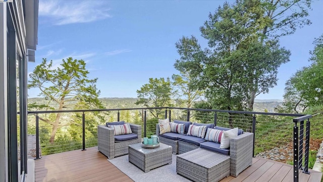 wooden terrace with an outdoor hangout area