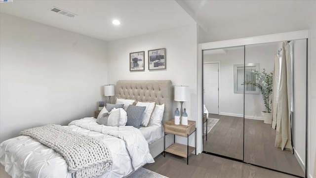 bedroom featuring wood-type flooring and a closet