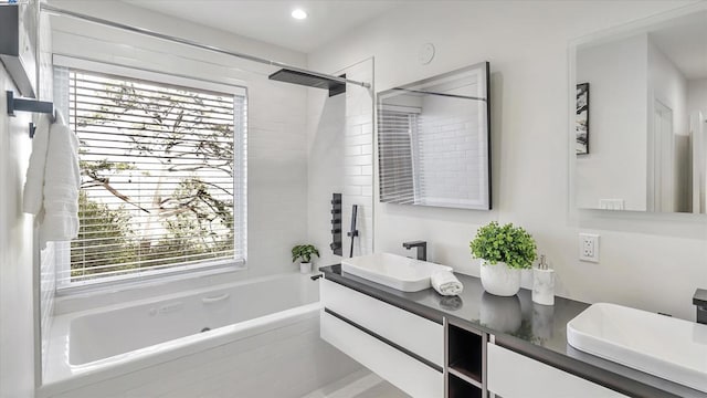 bathroom featuring vanity and tiled shower / bath