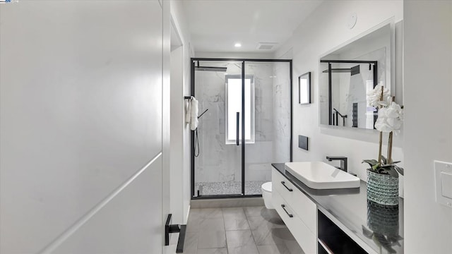 bathroom with vanity, toilet, and an enclosed shower