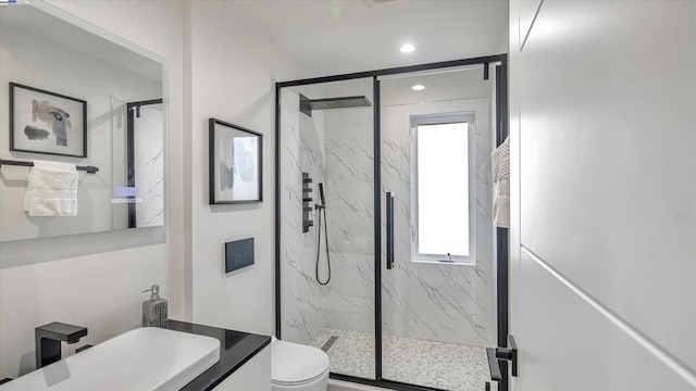 bathroom with toilet, vanity, and an enclosed shower