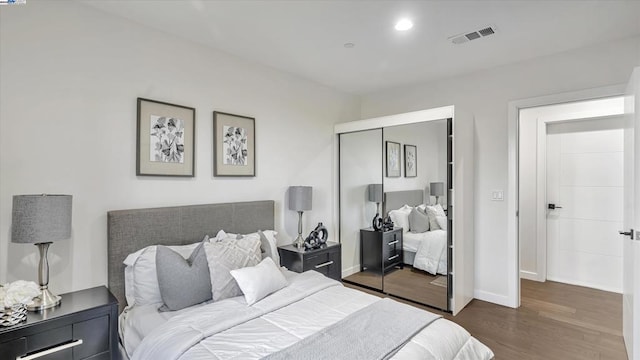 bedroom featuring a closet and dark wood-type flooring