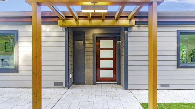 doorway to property with a patio and a pergola