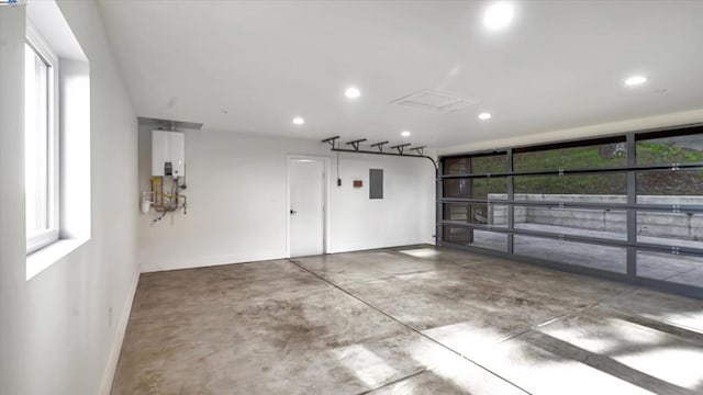 garage with electric panel and tankless water heater