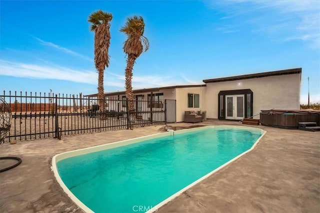 view of pool featuring french doors, a hot tub, and a patio area