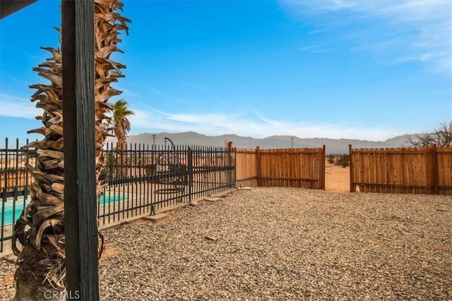 view of yard featuring a mountain view and a fenced in pool