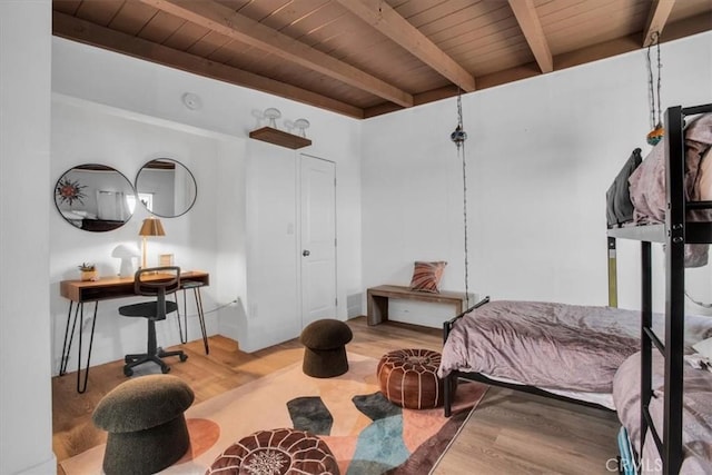 bedroom featuring wood-type flooring, wood ceiling, and beamed ceiling