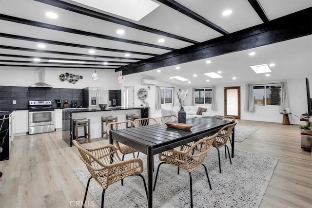 dining room featuring light hardwood / wood-style floors, beam ceiling, and a wall mounted air conditioner