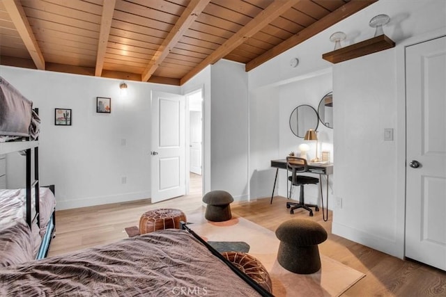 interior space featuring wooden ceiling, light hardwood / wood-style flooring, and vaulted ceiling with beams