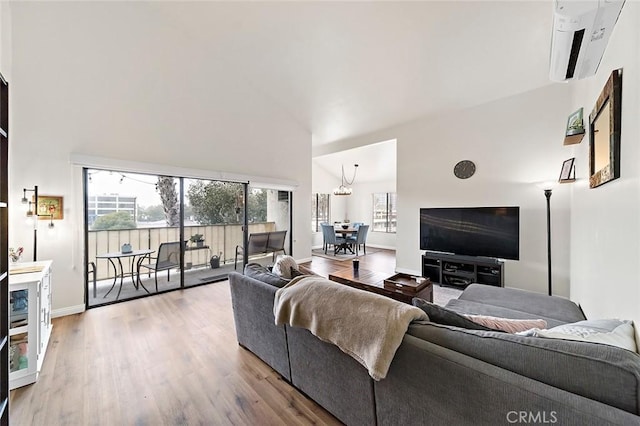 living room featuring lofted ceiling, a fireplace, and hardwood / wood-style flooring