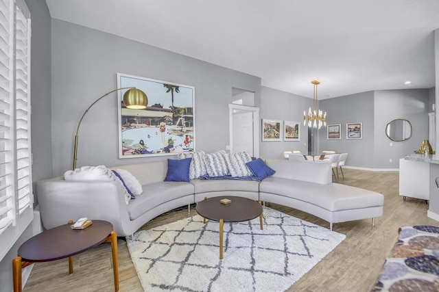 living room featuring light hardwood / wood-style flooring and a chandelier