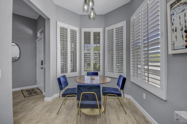 dining space with light hardwood / wood-style flooring