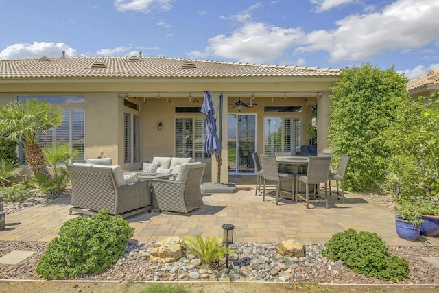 view of patio / terrace featuring ceiling fan and an outdoor living space