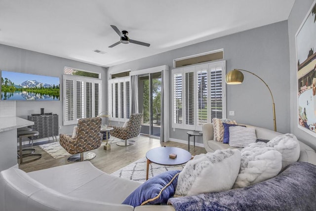 living room with ceiling fan and light hardwood / wood-style floors