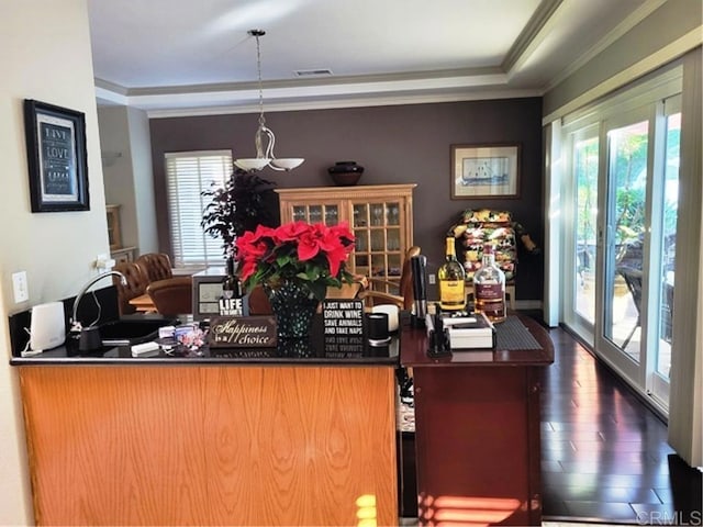 bar with dark wood-type flooring, hanging light fixtures, crown molding, and french doors