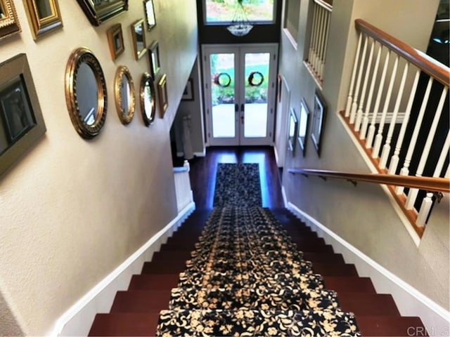 stairs with french doors