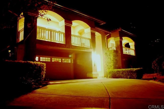 view of front of home featuring a balcony and a garage