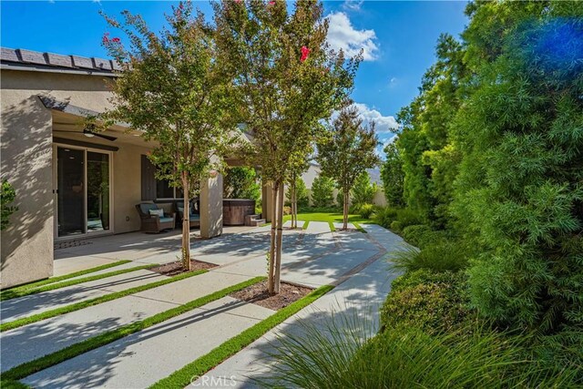 exterior space featuring a hot tub and a patio area