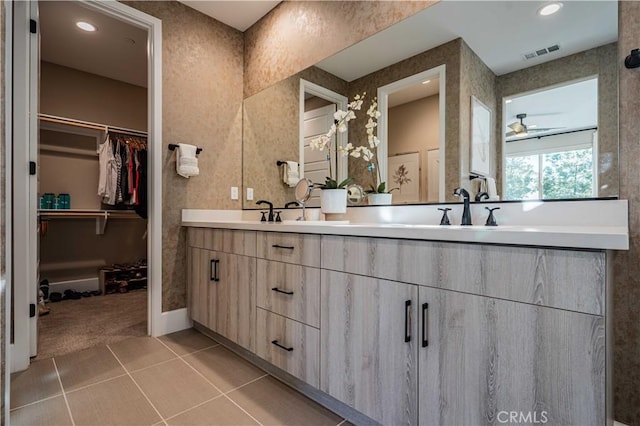 bathroom featuring ceiling fan, tile patterned floors, and vanity