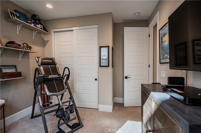 exercise room with light colored carpet