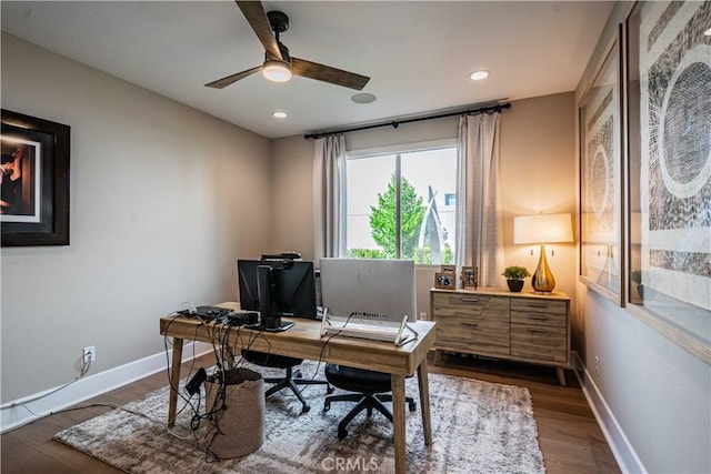 home office with ceiling fan and dark hardwood / wood-style flooring