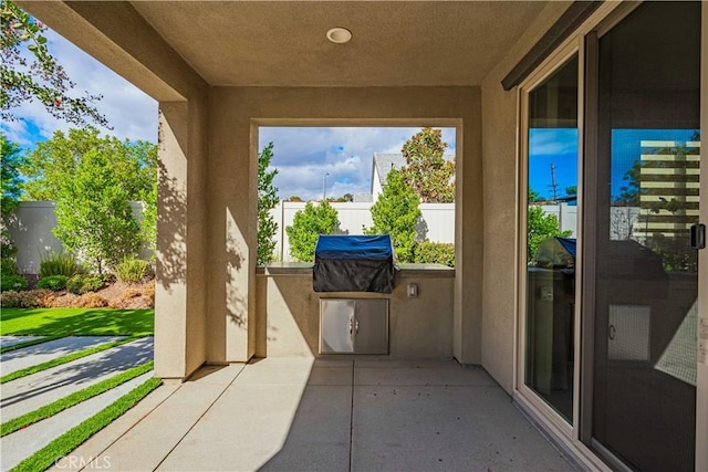 view of patio featuring a grill and an outdoor kitchen