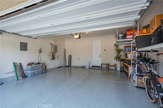 garage featuring electric panel, water heater, and a garage door opener