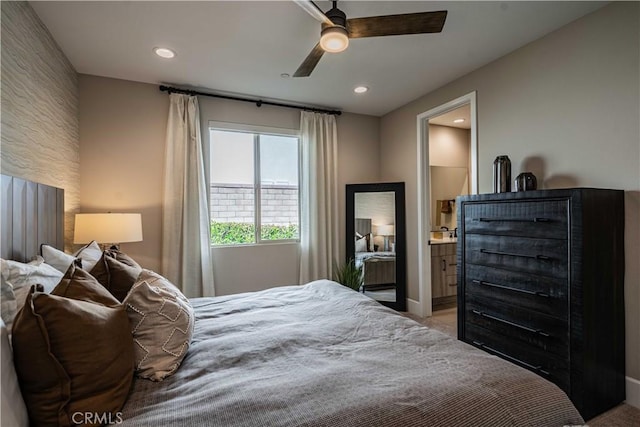 bedroom featuring ceiling fan and ensuite bath