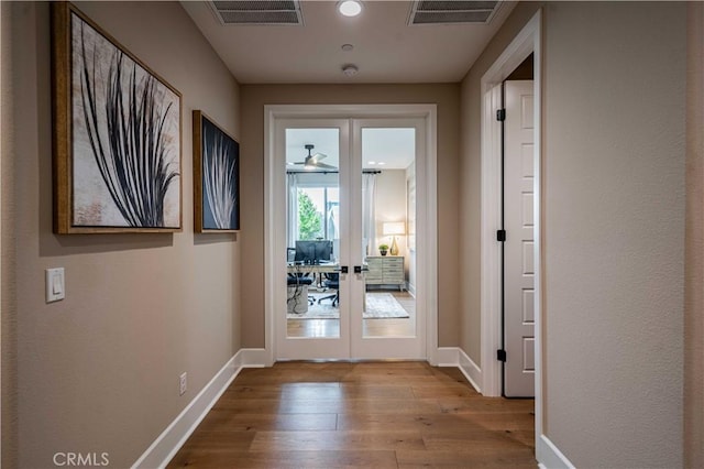 doorway featuring french doors, ceiling fan, and light hardwood / wood-style flooring