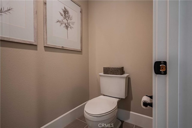 bathroom with toilet and tile patterned flooring