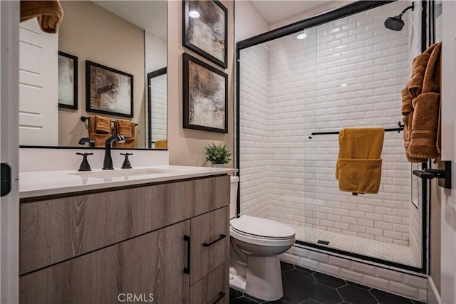 bathroom featuring toilet, vanity, tile patterned floors, and walk in shower