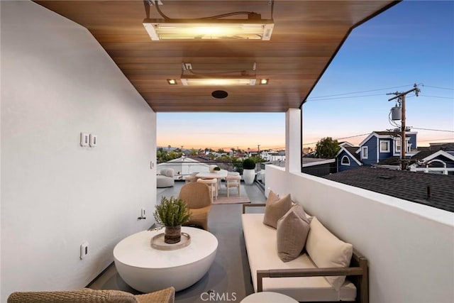 balcony at dusk featuring outdoor lounge area