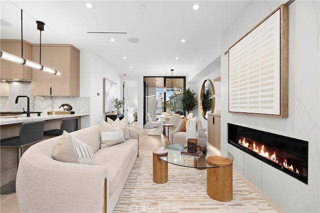 living room with sink and a large fireplace