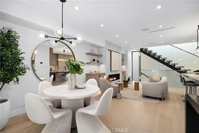 dining space with a chandelier and light wood-type flooring