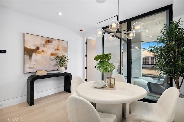 dining space featuring light hardwood / wood-style flooring and expansive windows